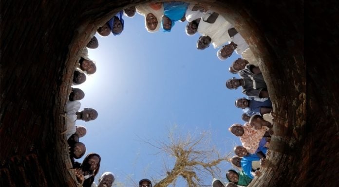 people looking down a hole