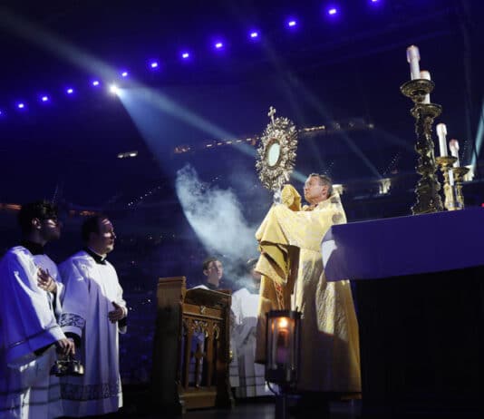 Bishop Andrew H. Cozzens of Crookston, Minn., chairman of the board of the National Eucharistic Congress Inc., blesses pilgrims July 17, 2024, during adoration at the opening revival night of the 10th National Eucharistic Congress at Lucas Oil Stadium in Indianapolis. Photo: OSV News photo/Bob Roller